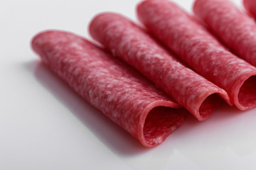 delicious sliced salami on a white background