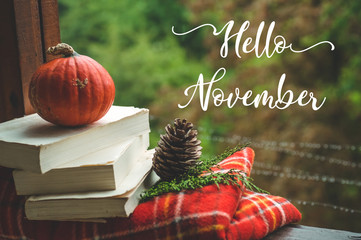 Hello November. Cozy autumn still life: cup and opened book on vintage windowsill with red blanket, pumpkin, candles. Autumn. Rain © Анастасія Стягайло