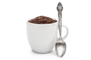 Fototapeta na wymiar Full cup of ground coffee with spoon on white.