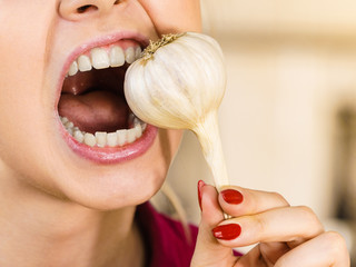 Crazy girl eating garlic vegetable