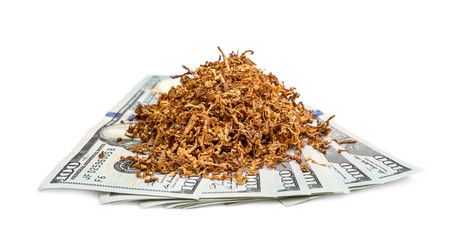 Pile of cut tobacco on dollar bills. Isolated on white.