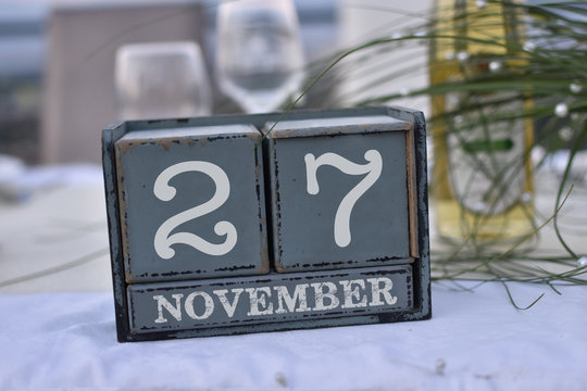 Wood blocks in box with date, day and month 27 November. Wooden blocks calendar