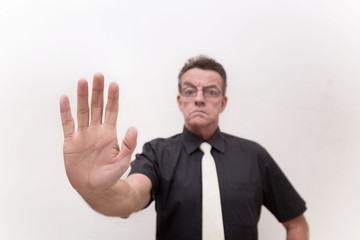 hand signal stop with serious face and strict gesture from strict man in black cloth and white tie on white background