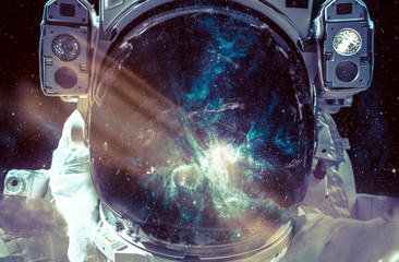 Dark nebula and stars in space, reflection on the spacesuit helmet. Adventure of spaceman. Astronaut in outer space. Elements of this image furnished by NASA. - Powered by Adobe