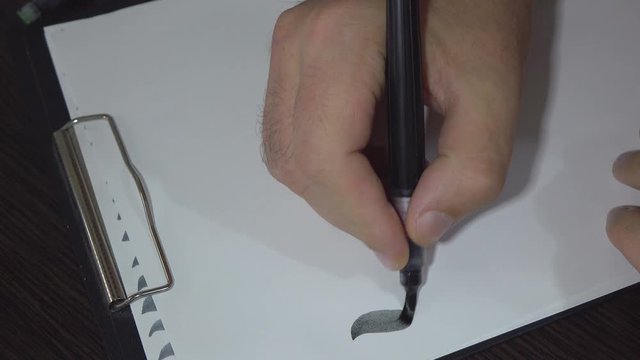 Man practiced in hand lettering with brush pen