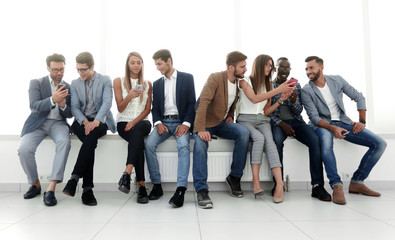 group of young people communicate in the waiting room.