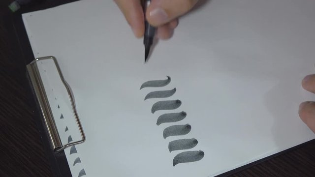 Man practiced in hand lettering with brush pen