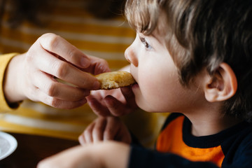 Little boy eating a biscuit 