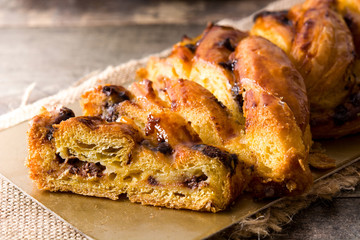 Homemade braid chocolate on wooden table. Close up
