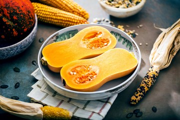 Pumpkin with different vegetables on the old wooden table top view ,Butternut