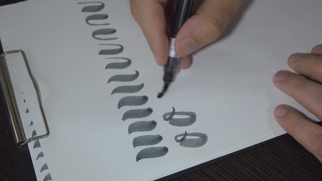 Man practiced in hand lettering with brush pen