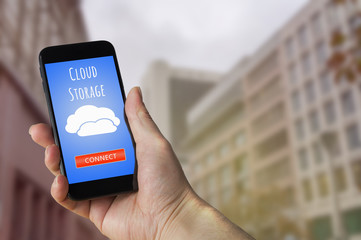 Datenzugriff von überall. Mann hält sein Mobiltelefon um sich mit seiner privaten Cloud zu...