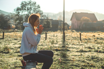 In the morning Girl closed her eyes, praying outdoors, Hands folded in prayer concept for faith, spirituality, religion concept.