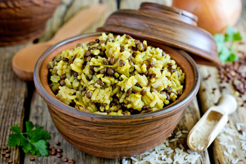 Mujadara - lentils and rice pilaf with caramelized onion on wooden background, middle eastern...