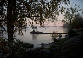 Lake Malaren in stockholm an early cold and foggy autumn day, shilouettes and reflextion in the...