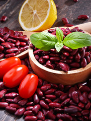 Composition with bowl of kidney bean on wooden table