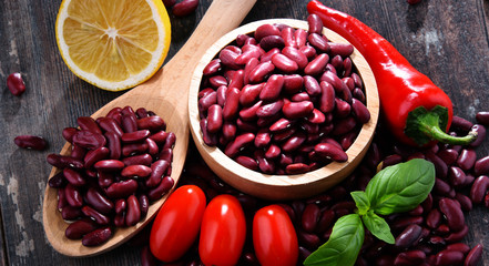 Composition with bowl of kidney bean on wooden table
