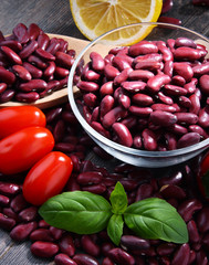 Composition with bowl of kidney bean on wooden table