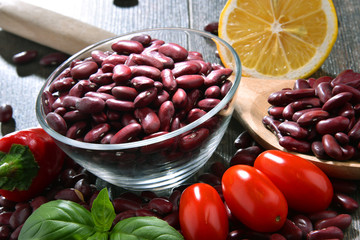 Composition with bowl of kidney bean on wooden table
