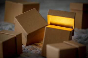 Small cardboard gift boxes with bokeh effect as concept of christmas sale.