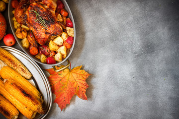 Served roasted Thanksgiving Turkey with vegetables and grilled corn on grey stone background © perikatipole