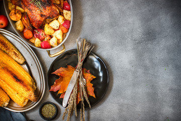Served roasted Thanksgiving Turkey with vegetables and grilled corn on grey stone background © perikatipole