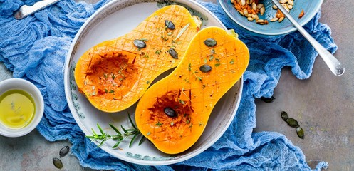Pumpkin with different vegetables on the old wooden table top view ,Butternut