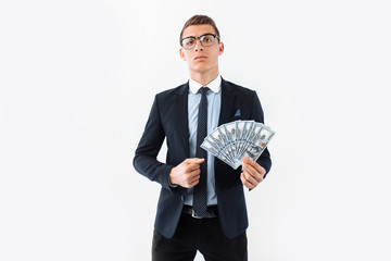 businessman wearing glasses and suit, holding a dollar bills on a white background.