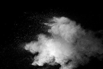 Explosion of white dust on black background.