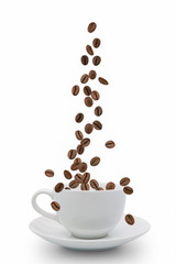 coffee beans falling into cup