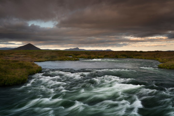 Blue river captured with long exposure among valley in South Iceland