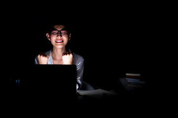 Woman working late at her home office close up.