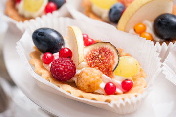 Fresh cupcake muffins with raw berries. Sweets decorated