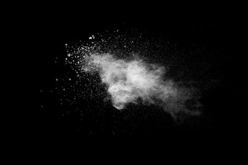 Explosion of white dust on black background.