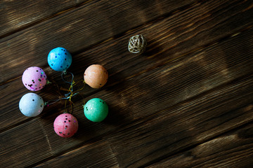 Christmas toys - six multi-colored balls on a dark natural background