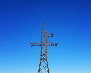 high voltage tower on background of blue sky
