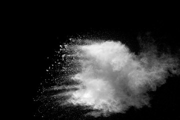 Explosion of white dust on black background.