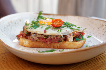 Fototapeta na wymiar Sandwich with beef tartar and fried egg