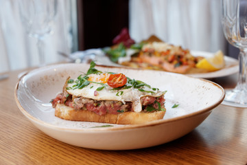 Sandwich with beef tartar and fried egg