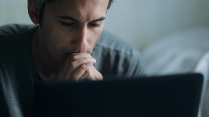 anxious man looking at laptop display - Powered by Adobe