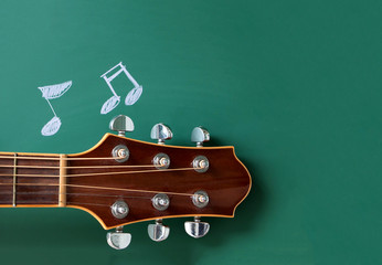 music school concept , guitar  and notes on  blackboard 