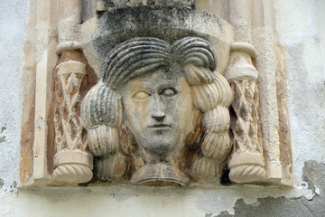 Fototapeta na wymiar Architectural detail with a mascaron of a woman on the facade of an old building in Varazdin, Croatia