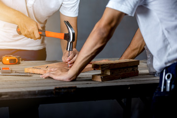 Carpenter man hammering a nail