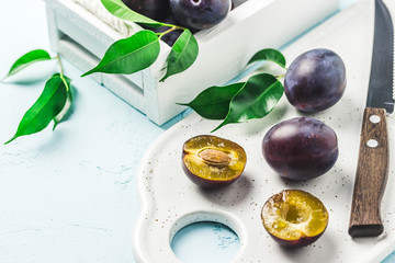 Ripe plums in a box. Selective focus, space for text.