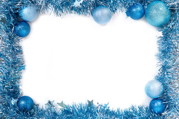 Blue christmas balls with blue tinsel on white background. New year frame. Isolated on white. New year 2019