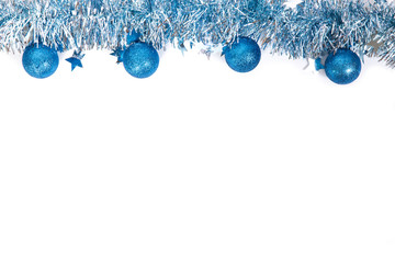 Blue christmas balls with blue tinsel on white background. New year frame. Isolated on white. New year 2019