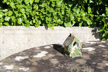 Stone birdhouse on stone table