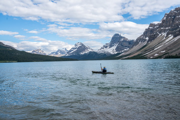 Man Kayaking on Banff Lake 