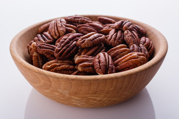 delicious pecan nuts on a white acrylic background