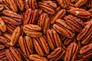 delicious pecan nuts on a dark stone background